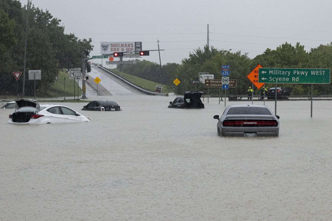 Stalled cars sit abandoned on the flooded Interstate 635 Service Road in Mesquite, Texas, on Monday.