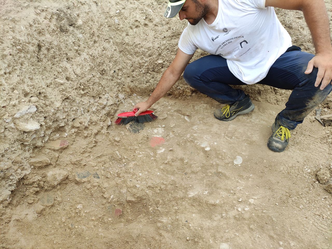 A red fragment is carefully recovered.