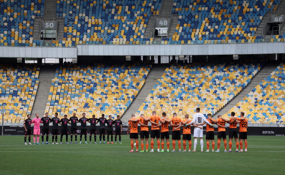 Shakhtar Donetsk and Metalist 1925 Kharkiv players during a moment of silence for people who have lost their lives as Russia's attack on Ukraine continues.