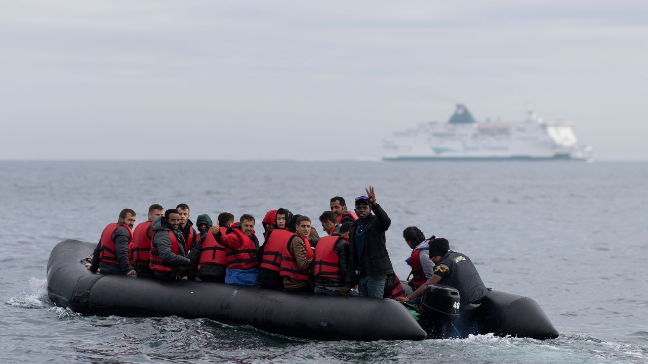 An inflatable craft carrying migrants crosses the shipping lane in the English Channel on August 4, 2022 off the coast of Dover, England. 