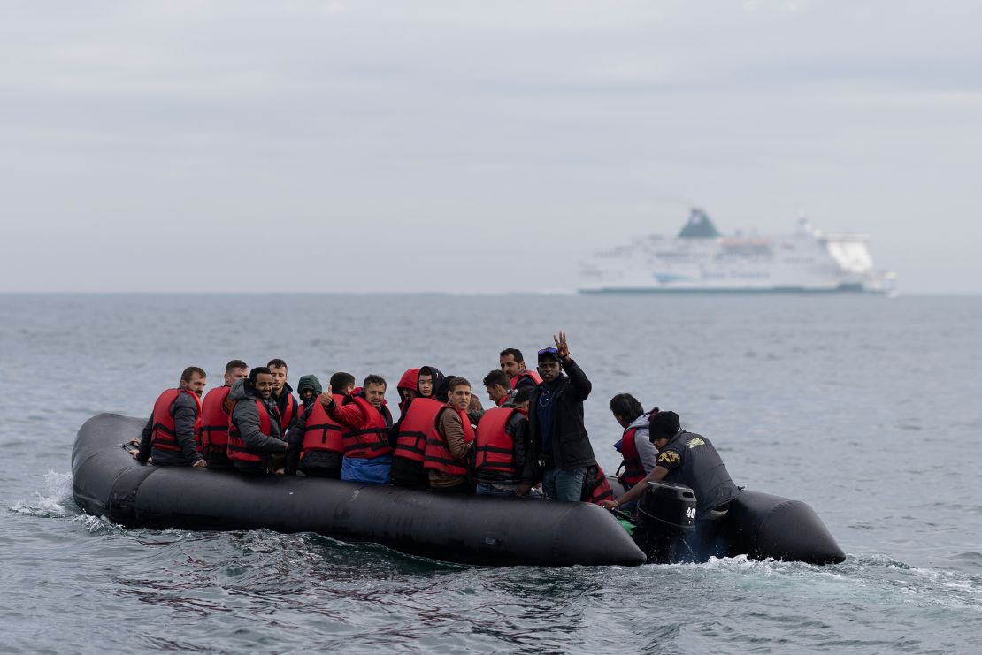  An inflatable craft carrying migrants crosses the shipping lane in the English Channel on August 4, 2022 off the coast of Dover, England.