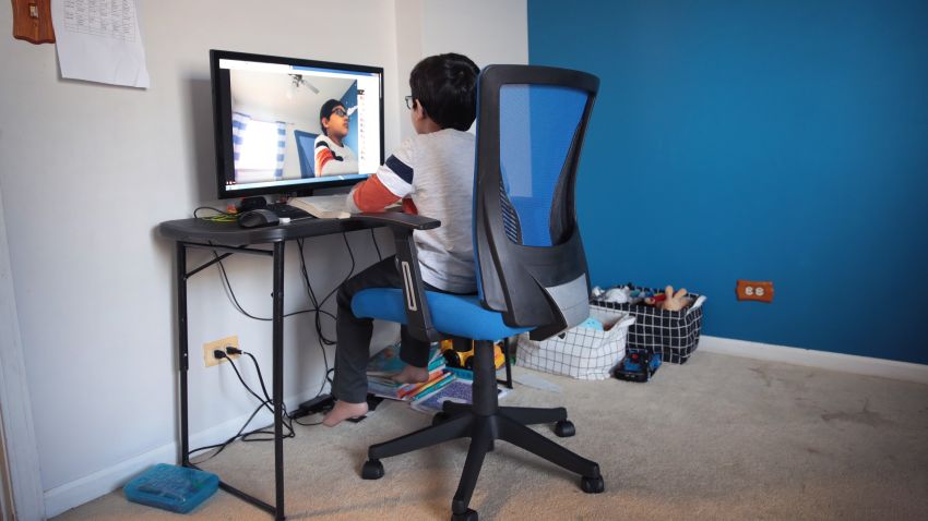 BARTLETT, ILLINOIS - MAY 01: Seven-year-old Hamza Haqqani, a 2nd grade student at Al-Huda Academy, uses a computer to participate in an E-learning class with his teacher and classmates while at his home on May 01, 2020 in Bartlett, Illinois. Al-Huda Academy, an Islam based private school that teaches pre-school through the 6th grade students, has had to adopt an E-learning program to finish the school year after all schools in the state were forced to cancel classes in an attempt to curtail the spread of the COVID-19 pandemic.  (Photo by Scott Olson/Getty Images)