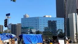 A homeless encampment with the LA Grand seen in the background. 