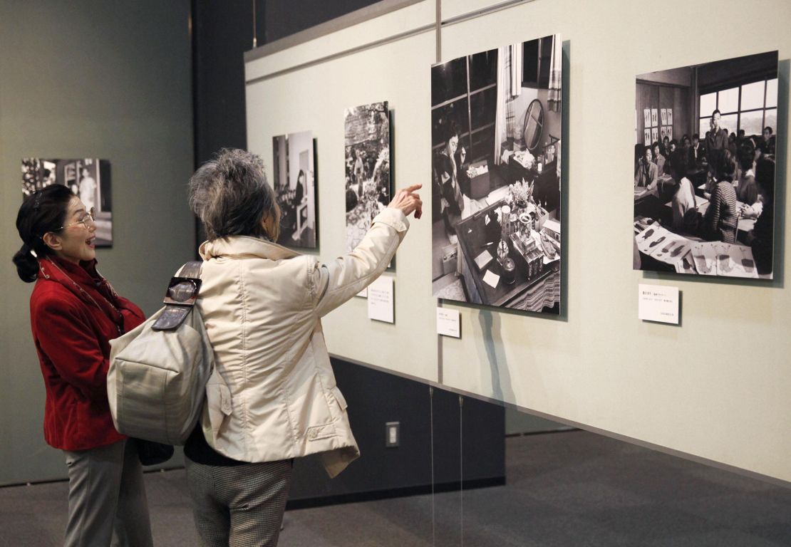 Visitors look at photos taken by Sasamoto at an exhibition celebrating her lifetime achievements at the Japan Newspaper Museum on April 5, 2014, shortly before her 100th birthday. 
