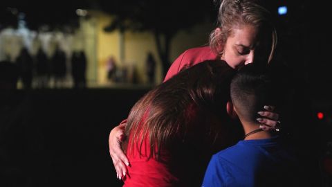 Families hug outside the Willie de Leon Civic Center in Uvalde, May 24, 2022.