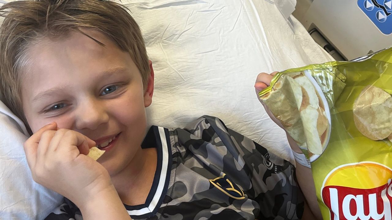 Cooper Roberts enjoys some chips as he no longer requires liquid food.