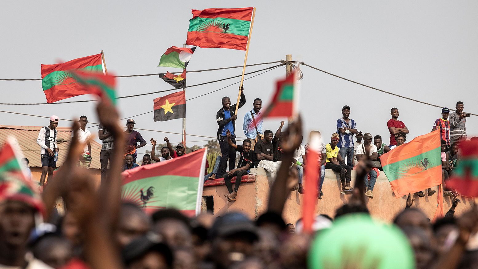Supporters of Angolan opposition party UNITA wave party flags during a campaign rally. 