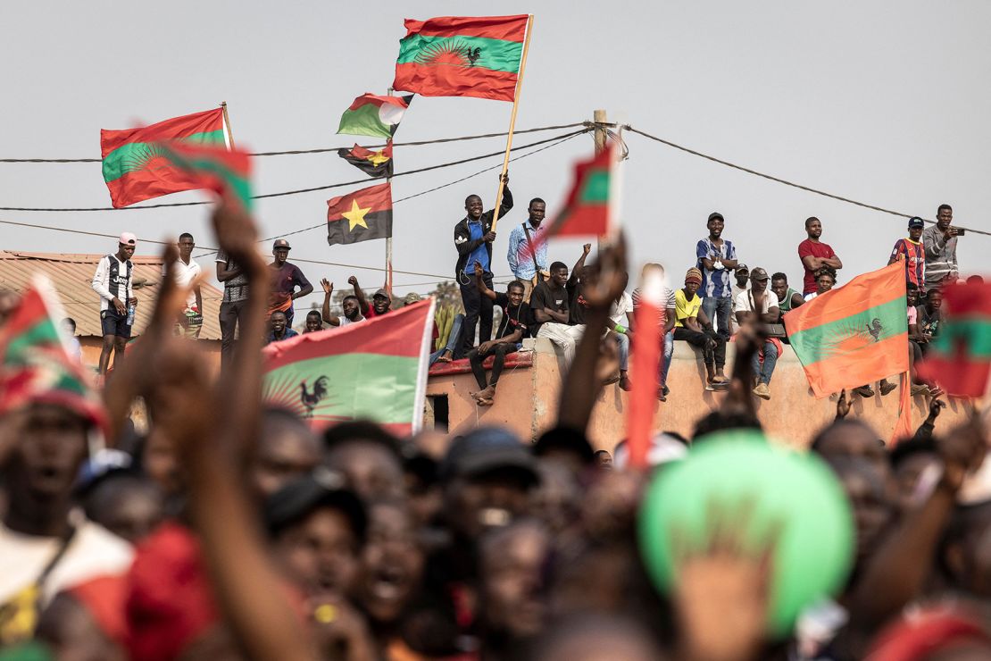 Supporters of Angolan opposition party UNITA wave party flags during a campaign rally.