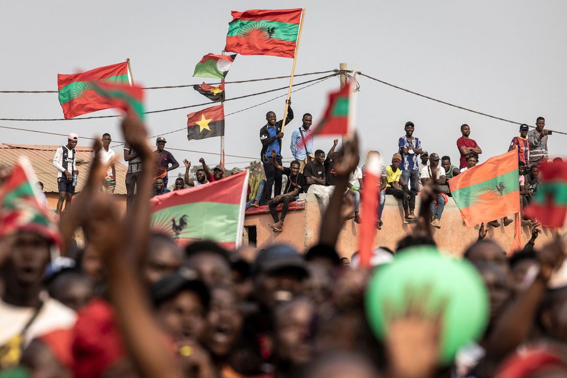 Supporters of Angolan opposition party UNITA wave party flags during a campaign rally. 