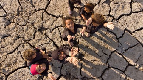 Children pose for an aerial photo on the dried-up bed of Iraq's receding southern marshes of Chibayish in Dhi Qar province on Tuesday.