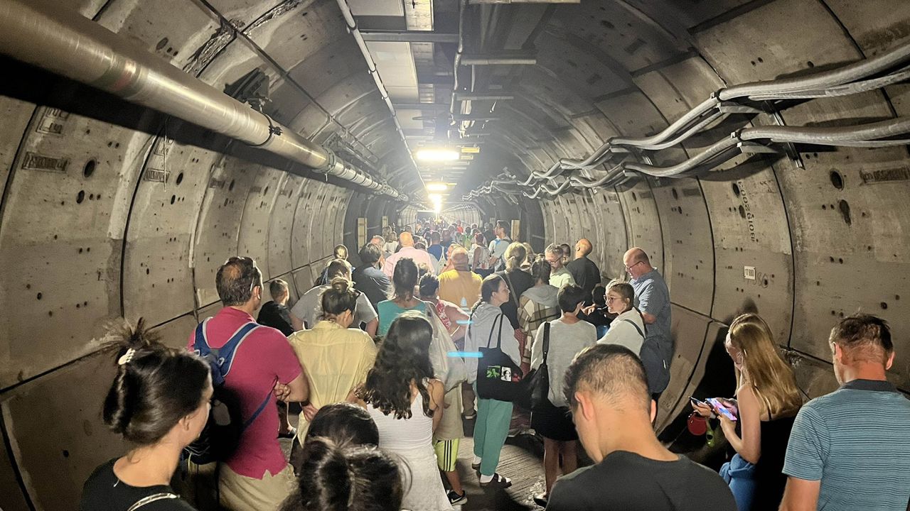 Passengers in an emergency tunnel after the train they were traveling on broke down.