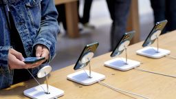 A customer views a Apple iPhone 13 Pro and Pro Max in the new green color during the sales launch at the Apple Inc. flagship store in New York, U.S., on Friday, March 18, 2022. 