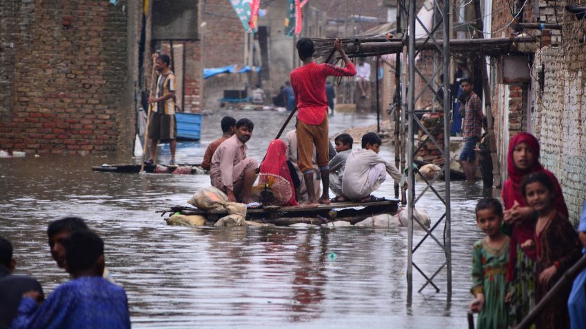 Residents use a raft to move along a waterlogged street in a residential area after a heavy monsoon rainfall in Hyderabad City on August 19, 2022. (Photo by Akram SHAHID / AFP) (Photo by AKRAM SHAHID/AFP via Getty Images)