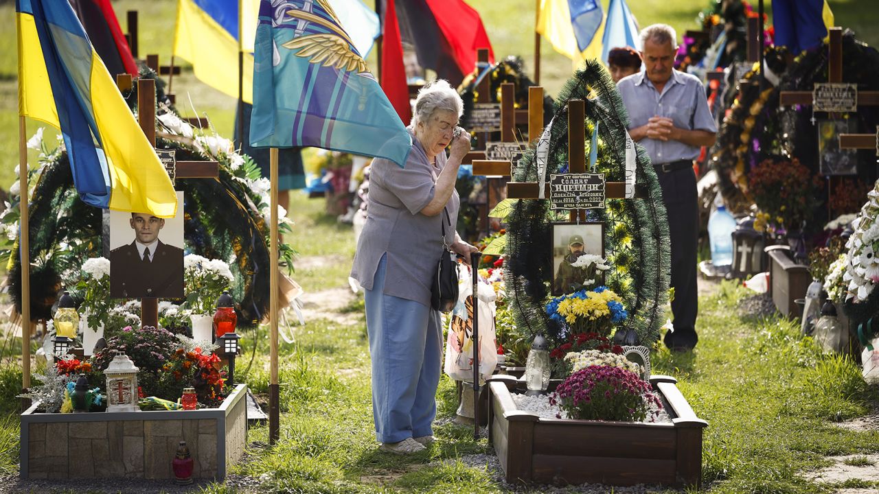 Family members of fallen soldiers attend a ceremony at the memorial, the Field of Mars.