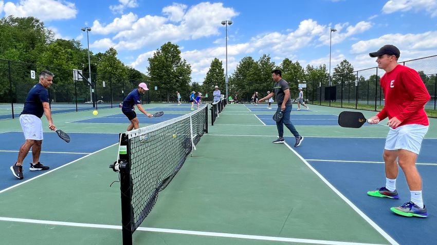 Professional pickleball player Ben Johns (2nd L), currently ranked number one in all three divisions of the sport, plays with his older brother Collin Johns (R), who is ranked number six, in Bethesda, Maryland, U.S. May 17, 2022. 