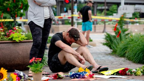 Mourners visit a memorial days after a mass shooting at a Fourth of July parade in Highland Park, Illinois.
