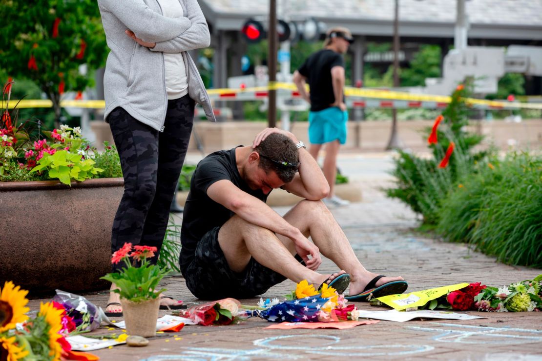 Mourners visit a memorial days after a mass shooting at a Fourth of July parade in Highland Park, Illinois.