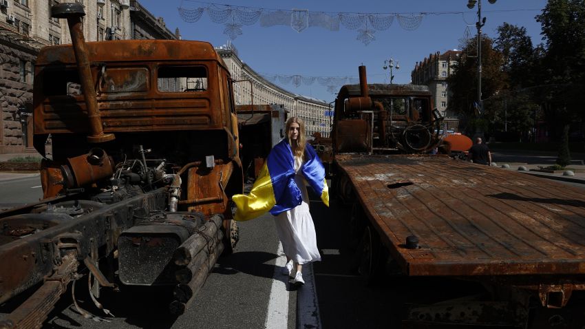 A woman walks by Russian military vehicles destroyed in the country's invasion of Ukraine in the Ukrainian capital of Kyiv on Aug. 24, 2022, the 31st anniversary of the country's independence from the Soviet Union. (Photo by Kyodo News via Getty Images)