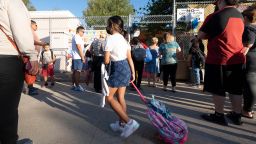 Children line up to enter Vena Elementary school in Arleta, CA Monday, August 15, 2022.
