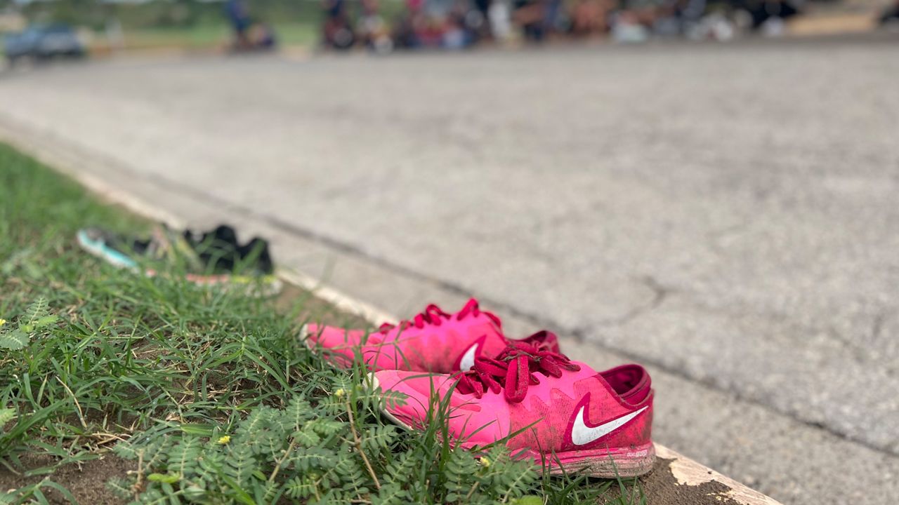 Migrants set their shoes out to dry on a curb after having crossed the Rio Grande in Eagle Pass, Texas.