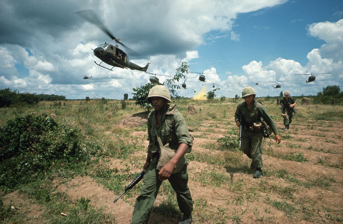 The US 173rd Airborne are supported by helicopters during the Iron Triangle assault in this Tim Page photo. 