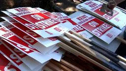 Members of the Kent Education Association assemble picket signs. 