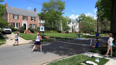 People play pickleball on an empty street in Charlotte during the early days of the coronavirus pandemic.