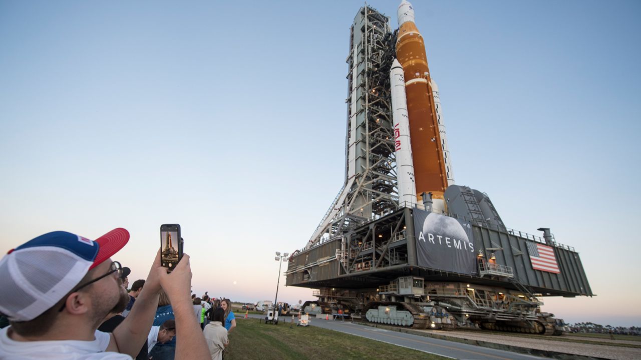 Invited guests and NASA employees take photos of NASA's Space Launch System rocket with the Orion spacecraft aboard at NASA's Kennedy Space Center in Florida in March. 