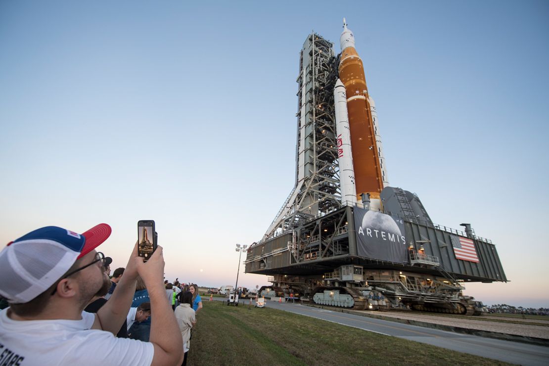 Invited guests and NASA employees take photos of NASA's Space Launch System rocket with the Orion spacecraft aboard at NASA's Kennedy Space Center in Florida in March. 