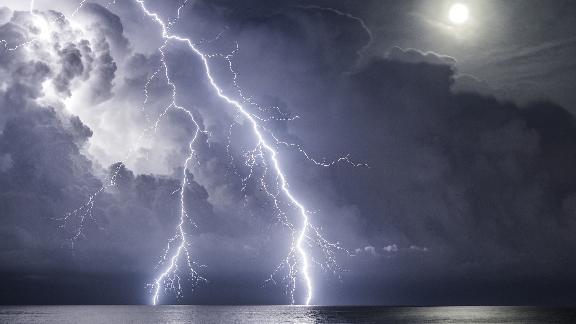 On a full moon night, with a storm moving away and one last lightning strike, was what photographer Enric Navarrete Bachs called 'dream lightning.'