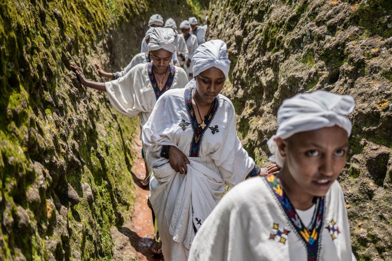 Young women walk through the cave of Saint George during the Ashenda festival at Saint George Church in Lalibela, Ethiopia, on Monday, August 22.