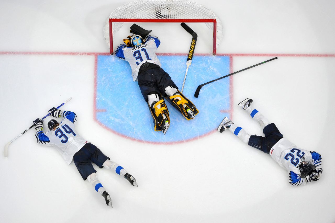 Finnish ice hockey players Aatu Raty, Juha Jatkola and Roni Hirvonen lay on the ice after losing the gold medal game against Canada in the IIHF World Junior Championship in Edmonton, Canada, on Saturday, August 20.