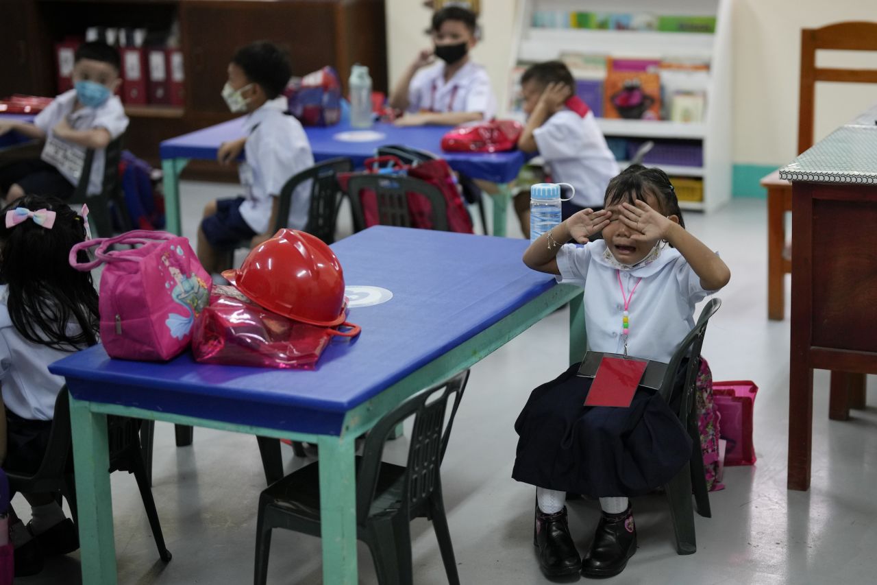 A girl cries during the first day of in-person classes at San Juan Elementary School in Manila, Philippines, on Monday, August 22.