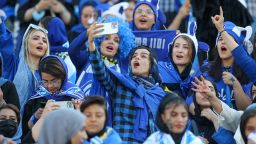Iranian women fans of Esteghlal football club cheer during a match between Esteghlal and Mes Kerman at the Azadi stadium in the capital Tehran, on August 25, 2022. - Iranian women were allowed today to attend a national football championship match for the first time since the 1979 Islamic Revolution, in a "historic" move, local media reported. (Photo by Hossein Zohrevand / TASNIM NEWS / AFP) (Photo by HOSSEIN ZOHREVAND/TASNIM NEWS/AFP via Getty Images)