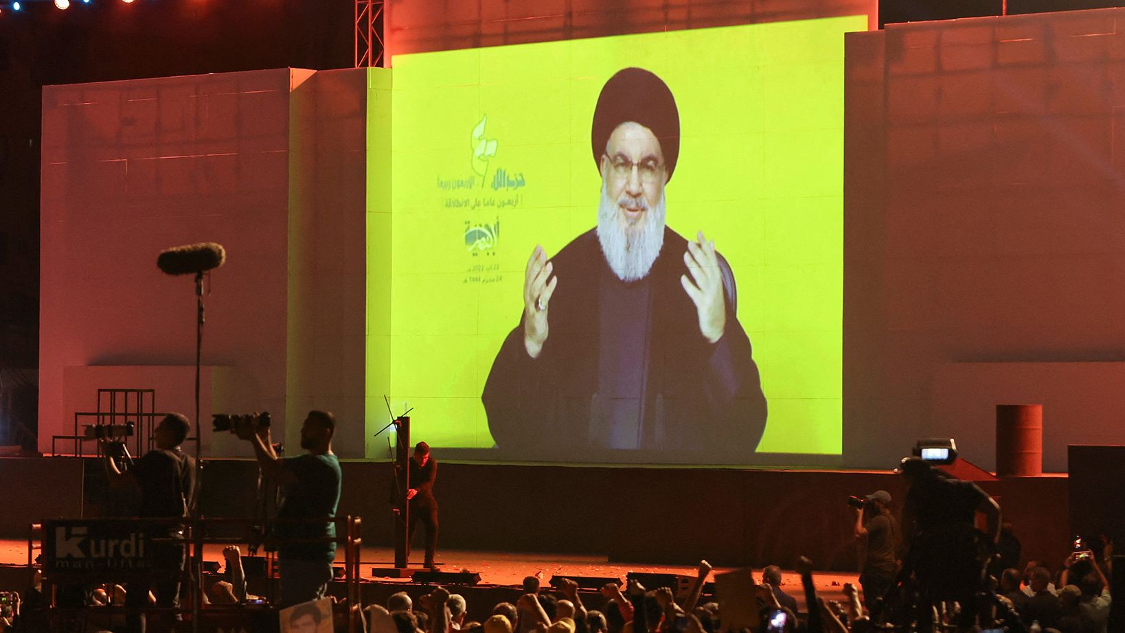 Lebanon's Hezbollah leader Hassan Nasrallah appears on a screen as he addresses his supporters during a rally in Beirut's southern suburbs in Lebanon on Monday.