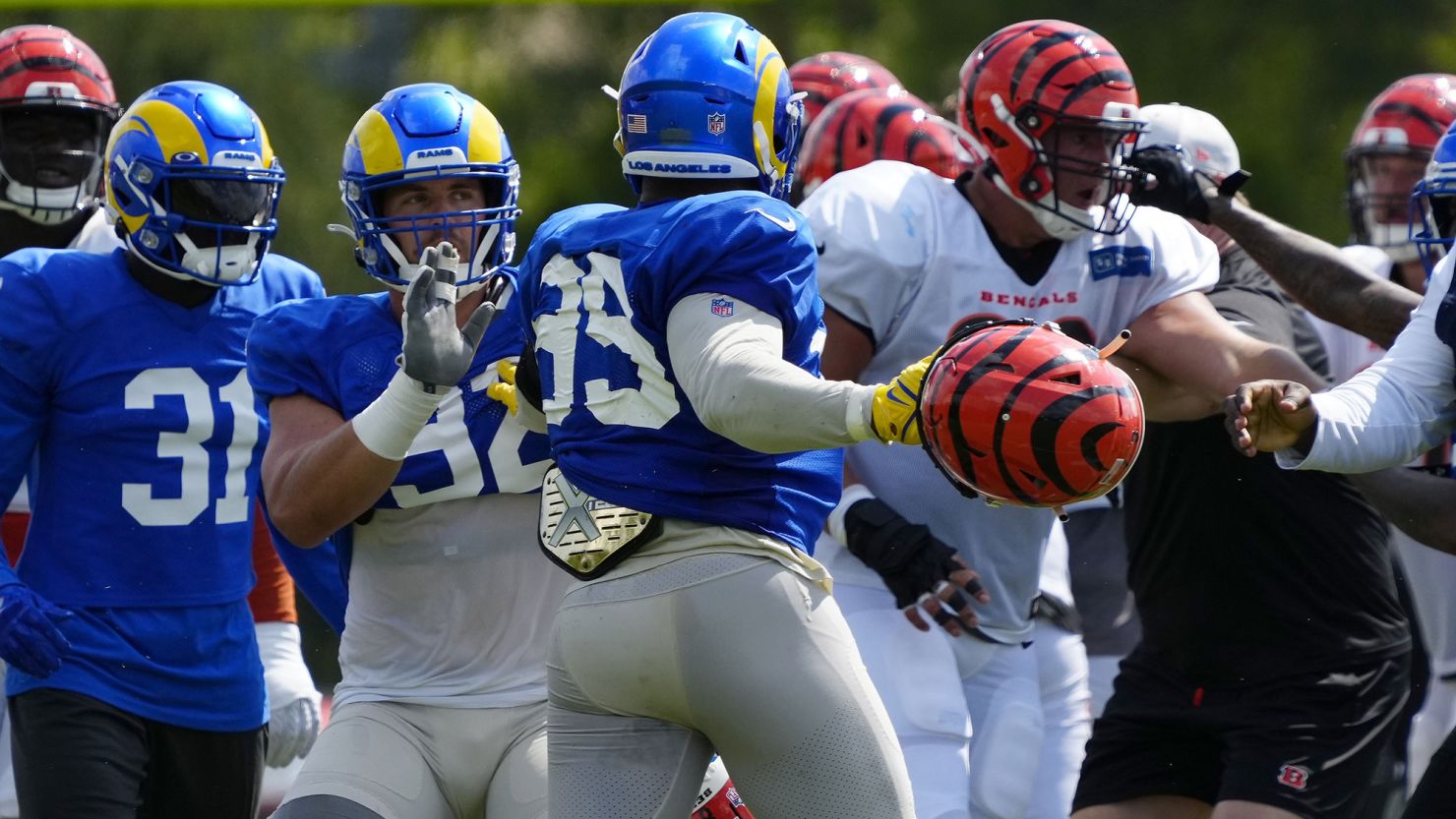 Los Angeles Rams defensive lineman Aaron Donald (99) swings a helmet during a joint practice between the Bengals and the Rams in Cincinnati.