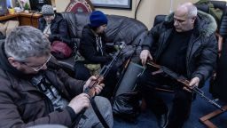 Civilian volunteers check their guns at a  Territorial Defence unit registration office on February 26, 2022 in Kyiv, Ukraine.