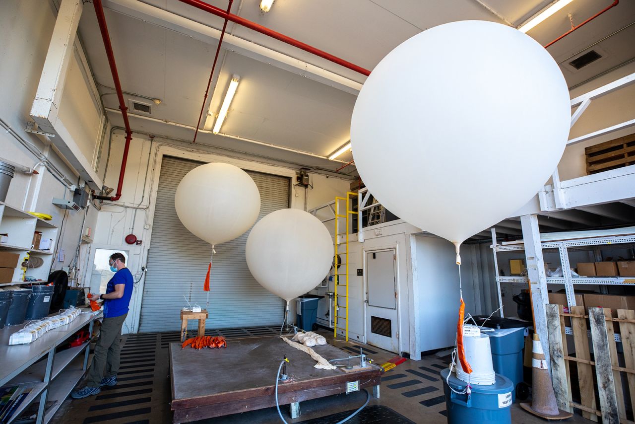 Michael Boyer, a meteorological data specialist, prepares weather balloons for an Artemis I weather simulation at Cape Canaveral on November 3, 2021.