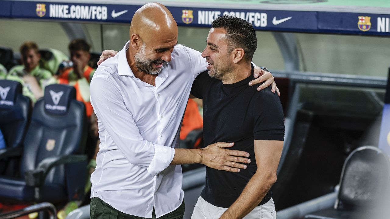 Guardiola (left) and Xavi (right) greet each other ahead of a charity match at the Camp Nou this week. 