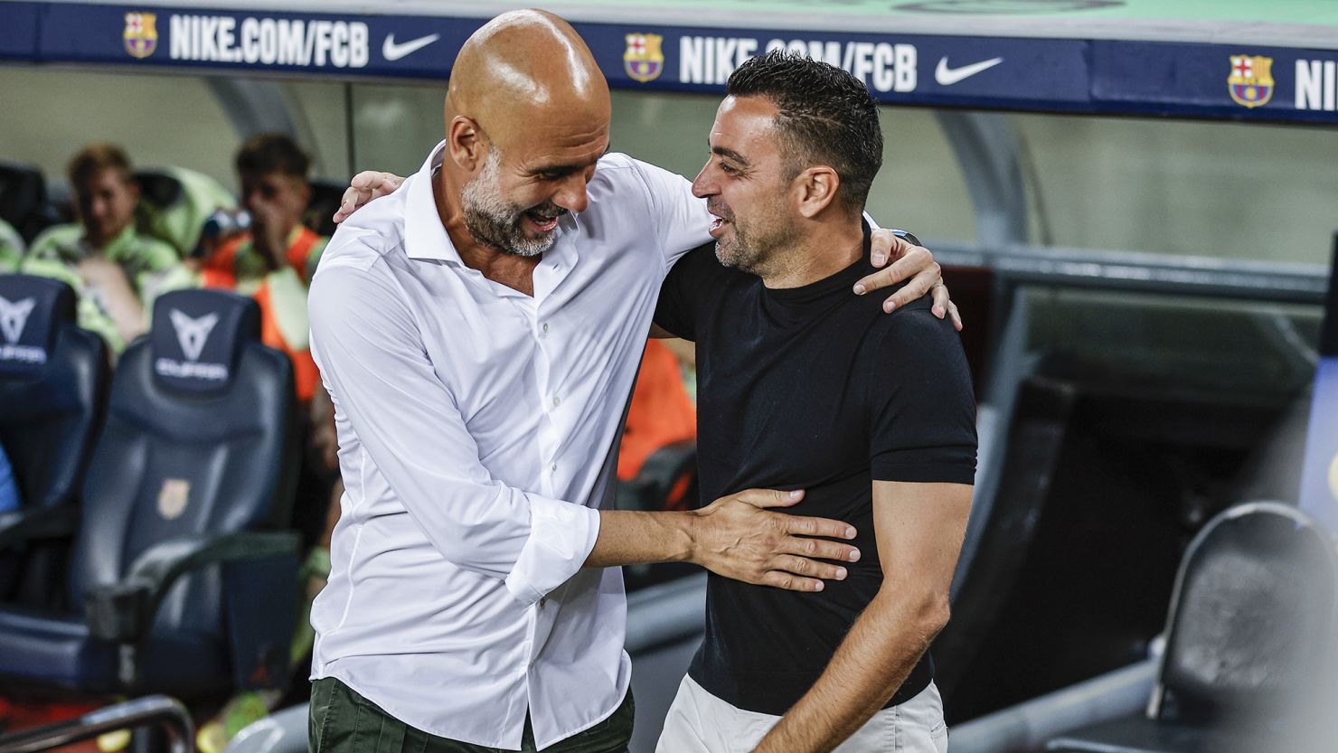 Guardiola (left) and Xavi (right) greet each other ahead of a charity match at the Camp Nou this week. 