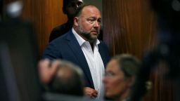 Alex Jones walks into the courtroom in front of Scarlett Lewis and Neil Heslin, the parents of 6-year-old Sand Hook shooting victim Jesse Lewis, at the Travis County Courthouse in Austin, Texas, U.S. July 28, 2022. 