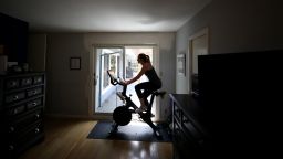 Jen Van Santvoord rides her Peloton exercise bike at her home on April 07, 2020 in San Anselmo, California. 