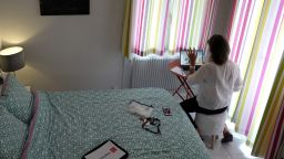 In this file photo taken on May 15, 2020 Manon, employee of global PR group Sagarmatha - Hopscotch, connects with her colleagues in Paris via videochat at her home office (teletravail) in the French riviera city of Nice.