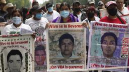 Family members and friends march seeking justice for the missing 43 Ayotzinapa students in Mexico City, Friday, Aug. 26, 2022. 