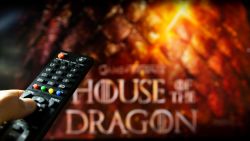 Belgrade, Serbia - July 22, 2022: House of the Dragon HBO TV series on TV with remote control in hand. Focuse on the remote. Story takes place 300 years before events portrayed in Game of Thrones about House Targaryen