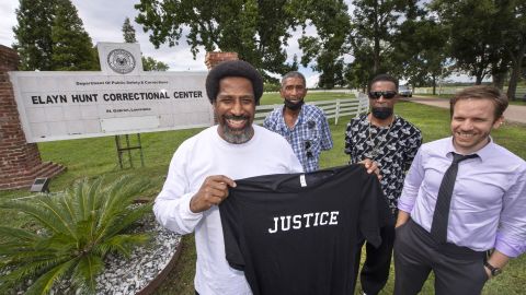 Sullivan Walter holds a shirt near Elayn Hunt Correctional Center in St. Gabriel, Louisiana, with, left to right, his brothers Joseph Walter, and Byron Walter Sr., and Innocence Project New Orleans Legal Director Richard Davis, just after his release on Thursday, August 25, 2022.