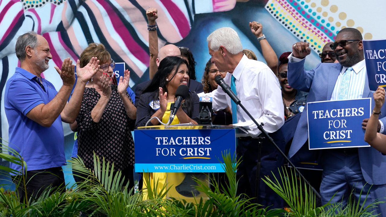 Florida Rep. Charlie Crist, second from right, stands with United Teachers of Dade President Karla Hernández-Mats, center, at an event in Miami Springs on May 31, 2022. 