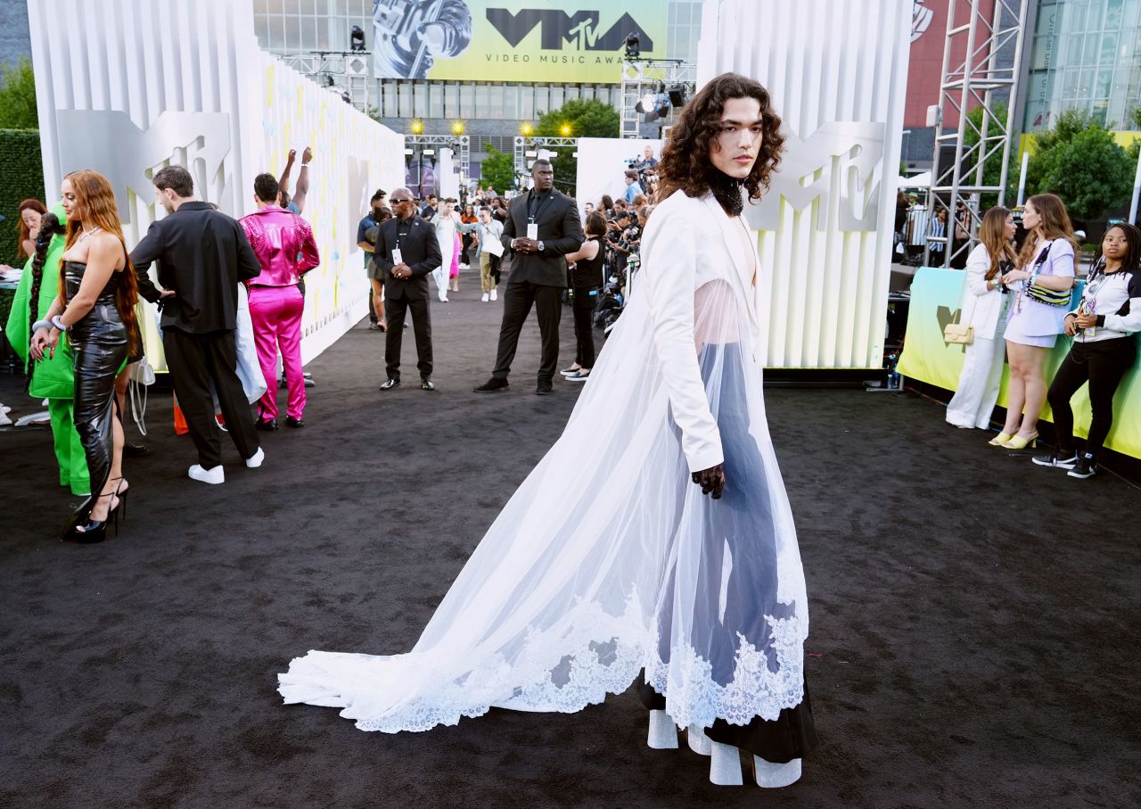Singer Conan Gray was a vision in white, wearing a whimsical Harris Reed ensemble with a lace-trimmed train and blazer.