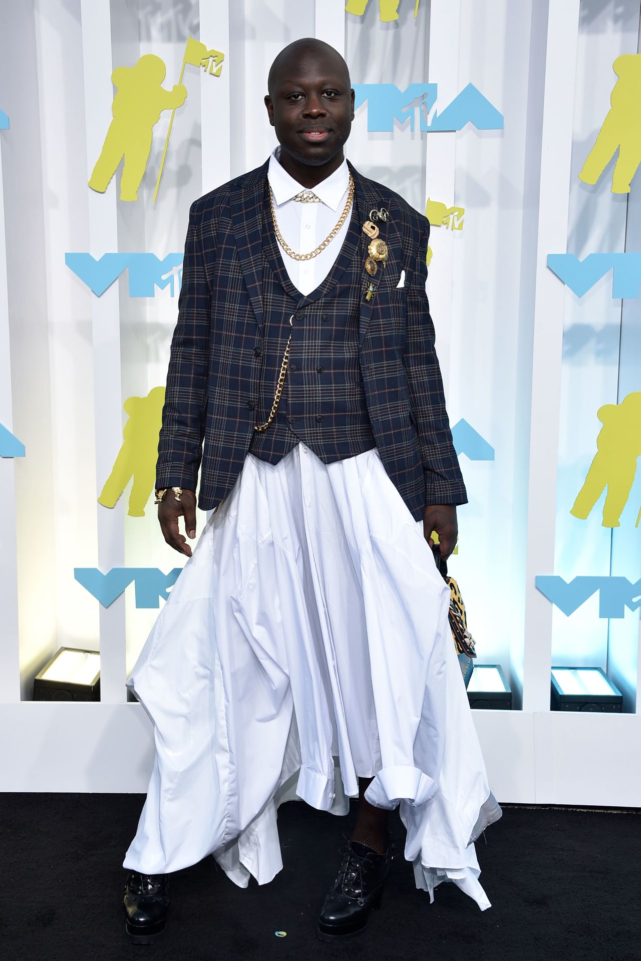 Bob the Drag Queen wore a gray plaid blazer, matching vest and white voluminous skirt.