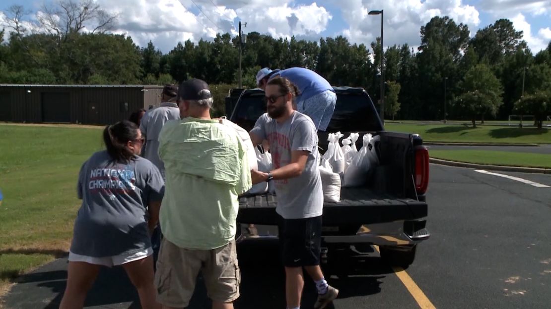 Residents pick up sand bags as flooding threat looms in Jackson, Mississippi.